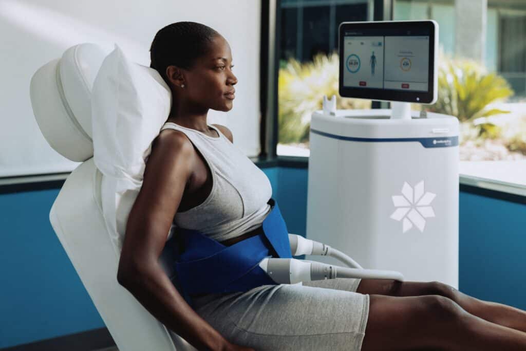 Woman relaxing during CoolSculpting treatment