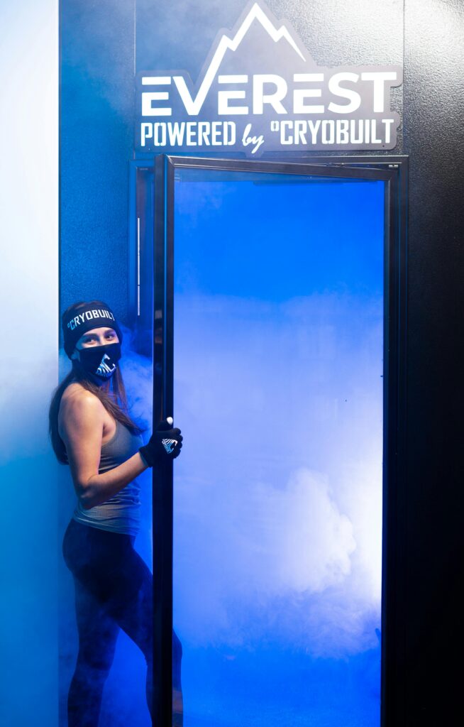 female client getting into cryotherapy chamber